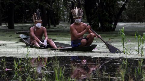 Satere-mawe indigenous men navigate the Ariau river during the COVID-19 novel coronavirus pandemic at the Sahu-Ape community, 80 km of Manaus, Amazonas State, Brazil, on May 5, 2020.