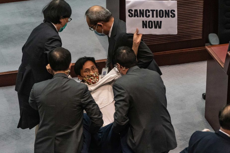Pro-democracy lawmaker Eddie Chu Hoi-dick is removed by security during a scuffle with pro-Beijing lawmakers at the Legislative Council in Hong Kong on May 22.