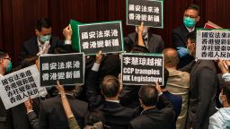 HONG KONG, CHINA - MAY 22:  Pro-democracy lawmakers hold placards to protest against the pro-Beijing lawmakers at the House Committee's election of vice chairpersons, presided by pro-Beijing lawmaker Starry Lee Wai-King at the Legislative Council on May 22, 2020 in Hong Kong, China. Chinese Premier Li Keqiang said on Friday during the National People's Congress that Beijing would establish a sound legal system and enforcement mechanism for safeguarding national security in Hong Kong. (Photo by Anthony Kwan/Getty Images)