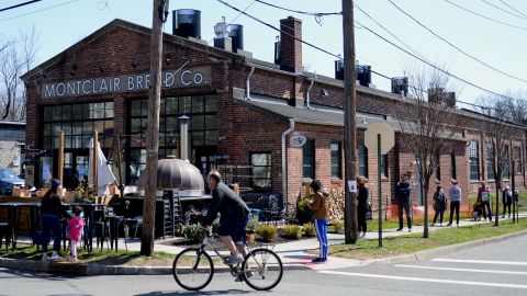 People practice social distancing while picking up Doughnuts and baked goods from The Montclair Bread Co. on Wednesday March 18, 2020 in Montclair, New Jersey.