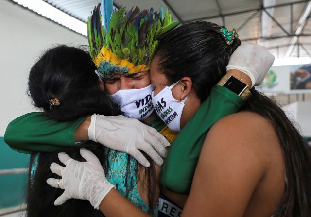 Miqueias Moreira Kokama, son of indigenous Chief Messias Kokama, hugs relatives at his father's funeral in Manaus on May 14. Messias Kokama was 53.