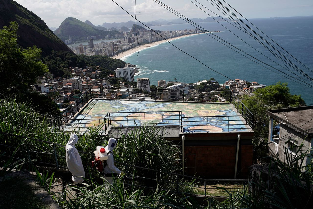 Water utility workers disinfect a favela in Rio on April 24.
