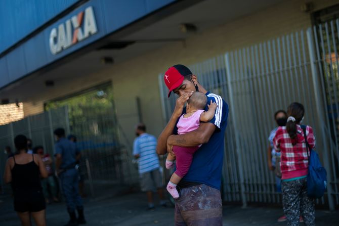 A man waits outside a Rio bank to receive government benefits on May 20.