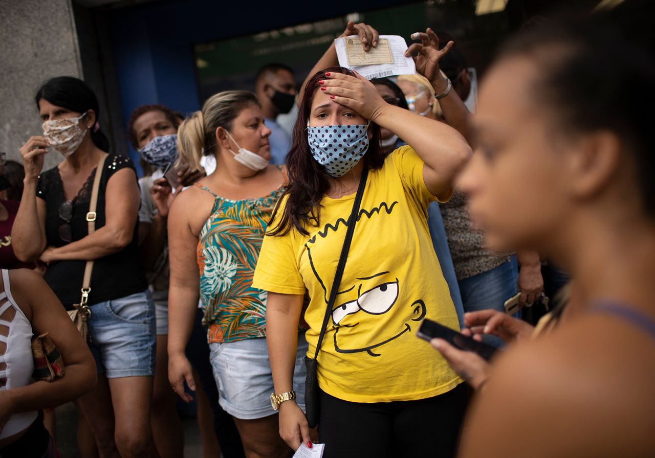 People in Rio wait outside a government-run bank for aid money on April 28.