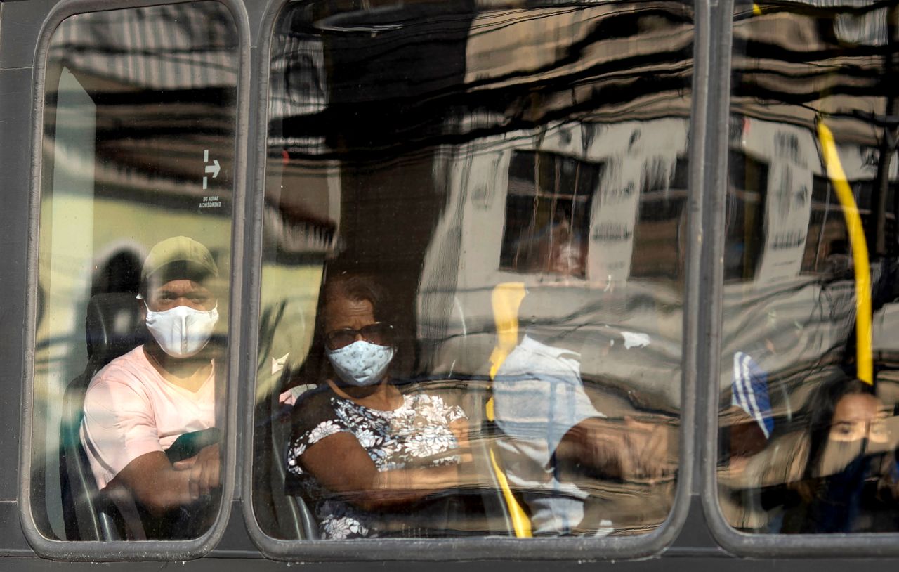 Commuters peer through a bus window in Rio on May 12.