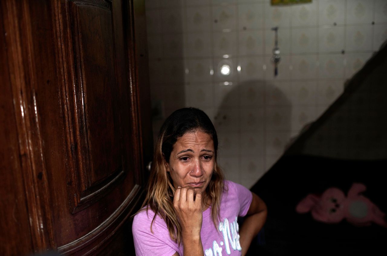 Manicurist Flavia Ferreira cries while she talks about her situation in Rio on April 15. Ferreira hadn't worked since a quarantine was put in place in Rio. She received donations of food from a cultural center and from neighbors in her favela.