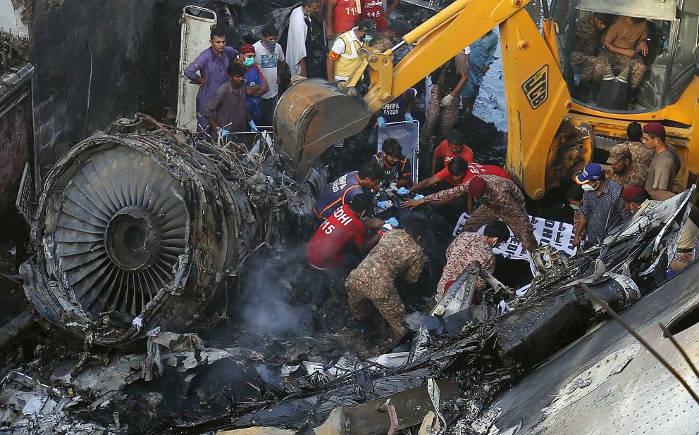 Officials work to salvage the wreckage.