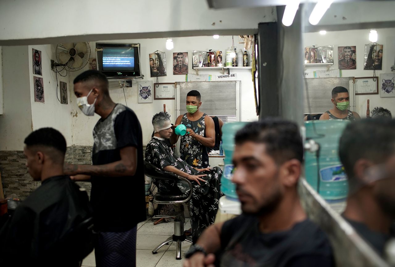 Barbers wear protective face masks as they work in a Rio favela on April 21.