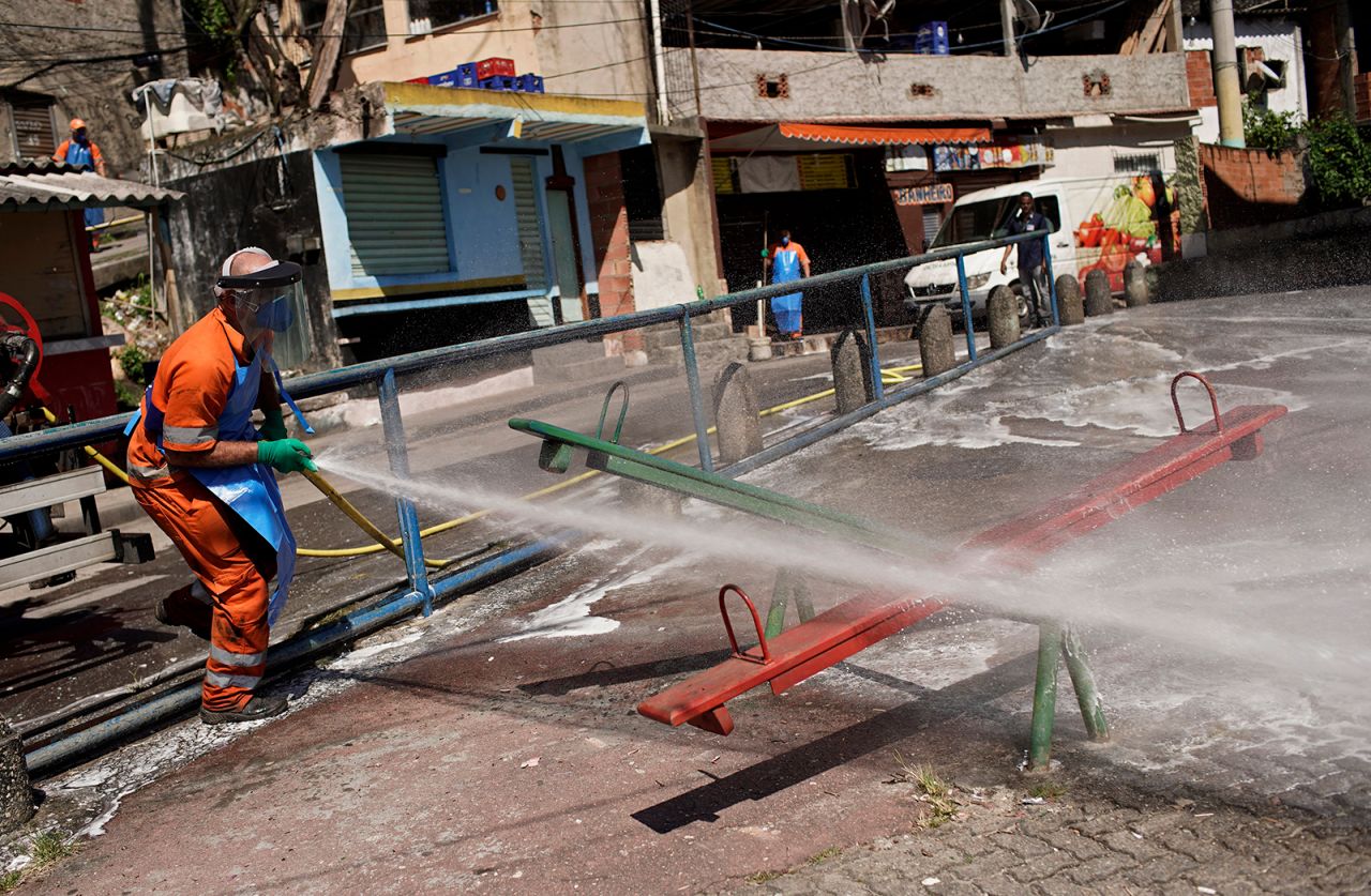 A city worker disinfects playground equipment in the Andarai favela in Rio on April 13.
