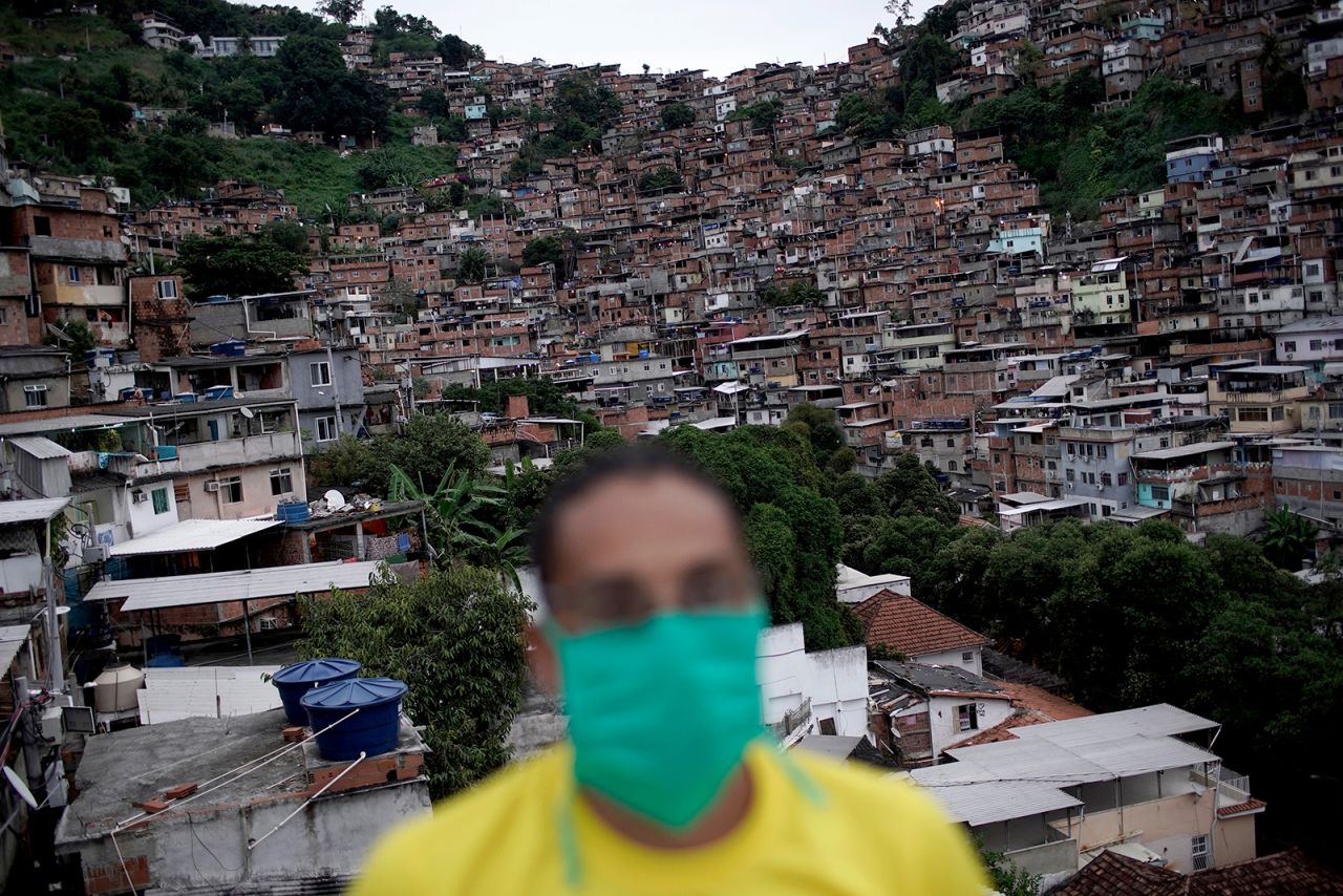 A member of a cultural center wears a mask in Rio's Turano favela on April 15.