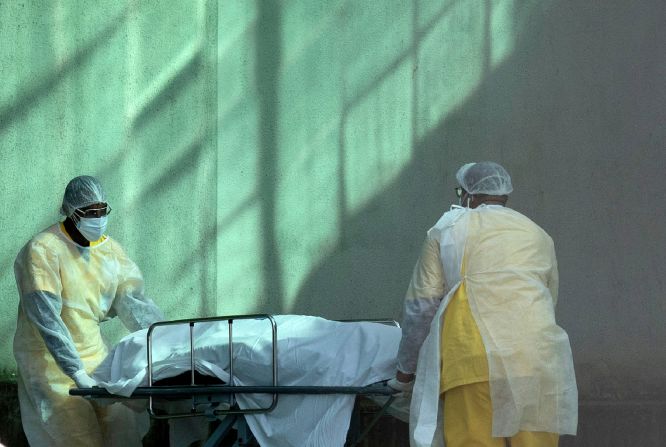 Health workers in Rio move a body from cold storage on May 5.