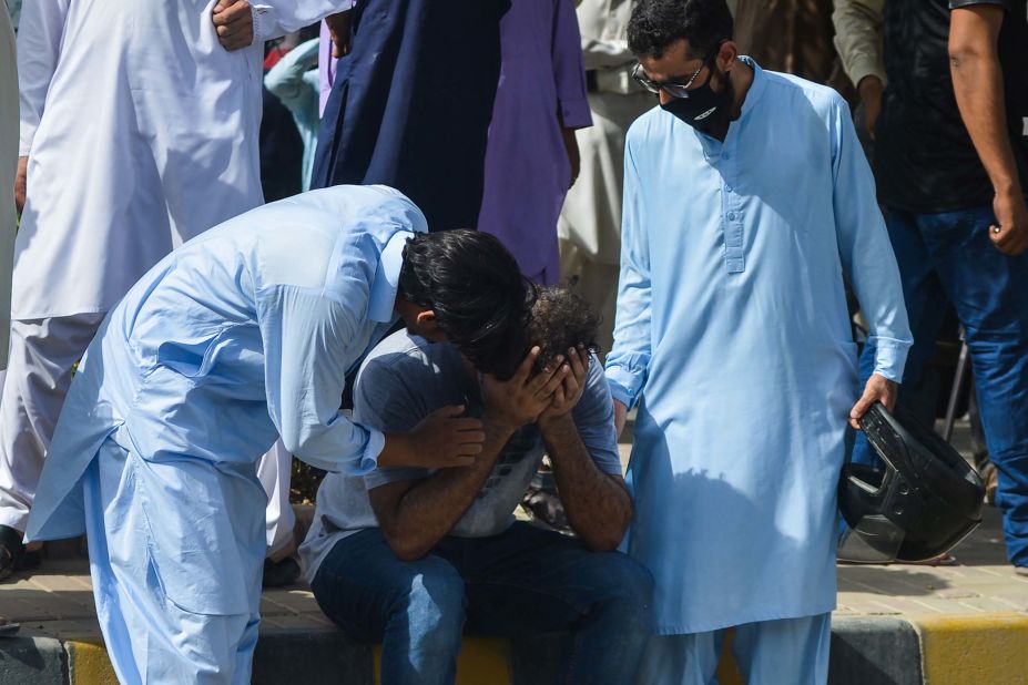 A person is comforted near the site of the crash.