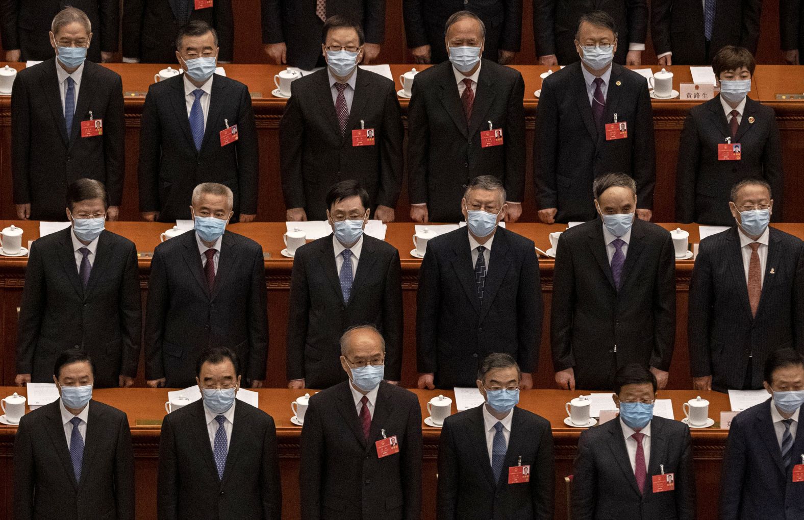 Chinese Communist Party delegates stand for the national anthem at the opening of the National People's Congress on May 22. The annual parliamentary gathering had been postponed.