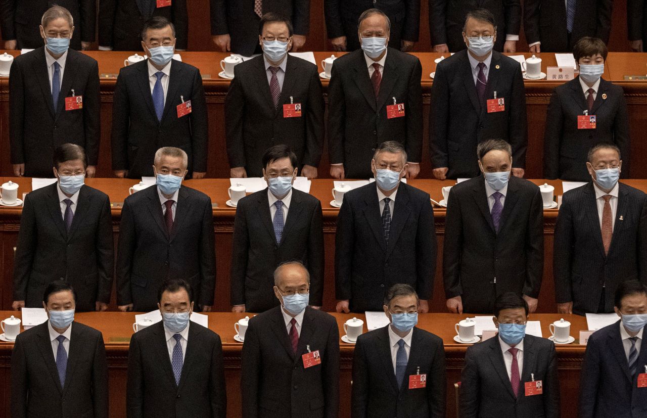 Chinese Communist Party delegates stand for the national anthem at the opening of the National People's Congress on May 22. The annual parliamentary gathering had been postponed.