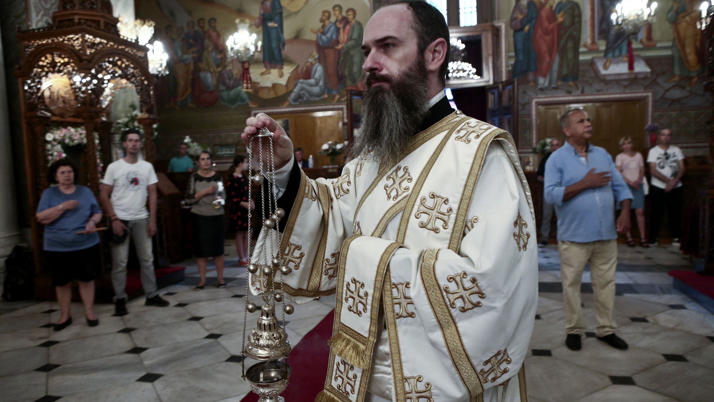 Christian Orthodox faithfuls attend a liturgy in Athens, Greece, on May 20.