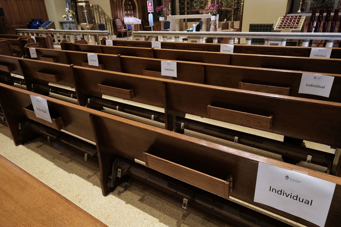 Church pews are marked with signs to allow congregants to practice social distancing. 