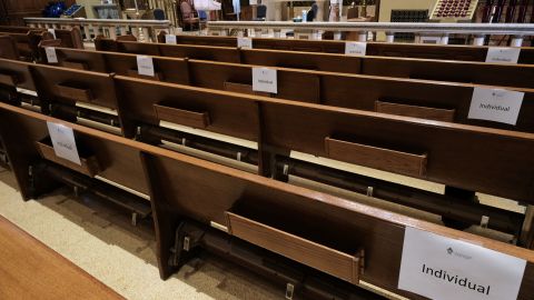 Church pews are marked with signs to allow congregants to practice social distancing.