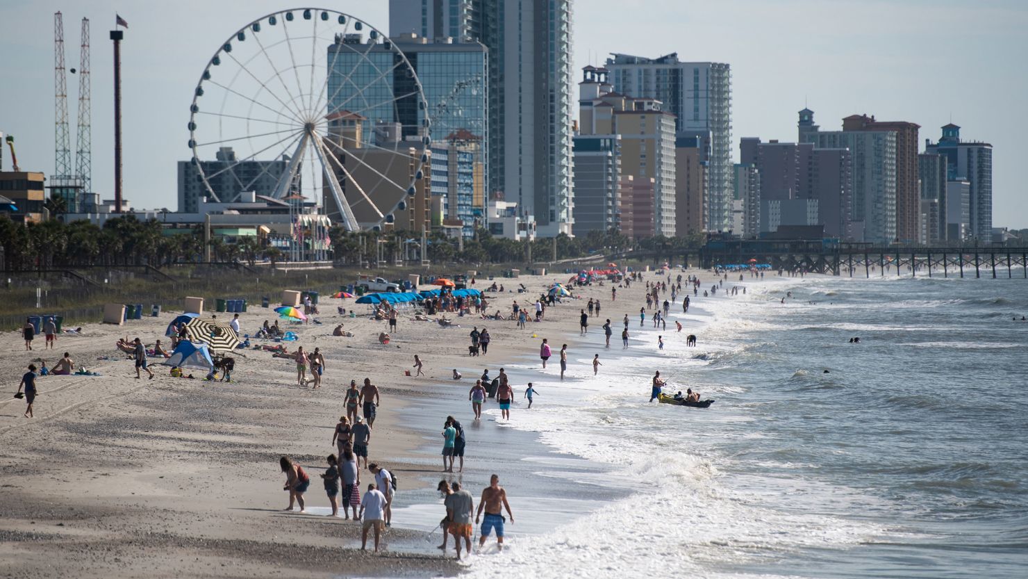 People walk and gather along the beach on the morning of May 23 in Myrtle Beach, South Carolina. 
