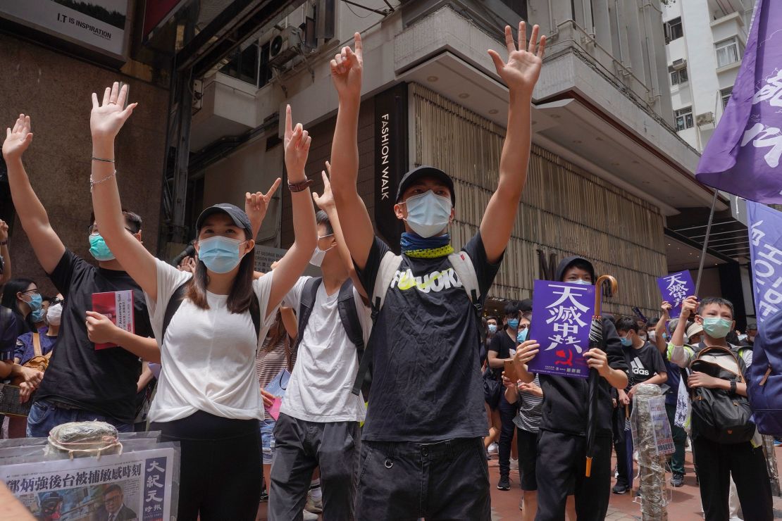 Protesters march along a downtown street during a pro-democracy protest against Beijing's national security legislation in Hong Kong, Sunday, May 24, 2020.  