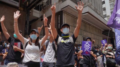 Protesters march along a downtown street during a pro-democracy protest against Beijing's national security legislation in Hong Kong, Sunday, May 24, 2020.  