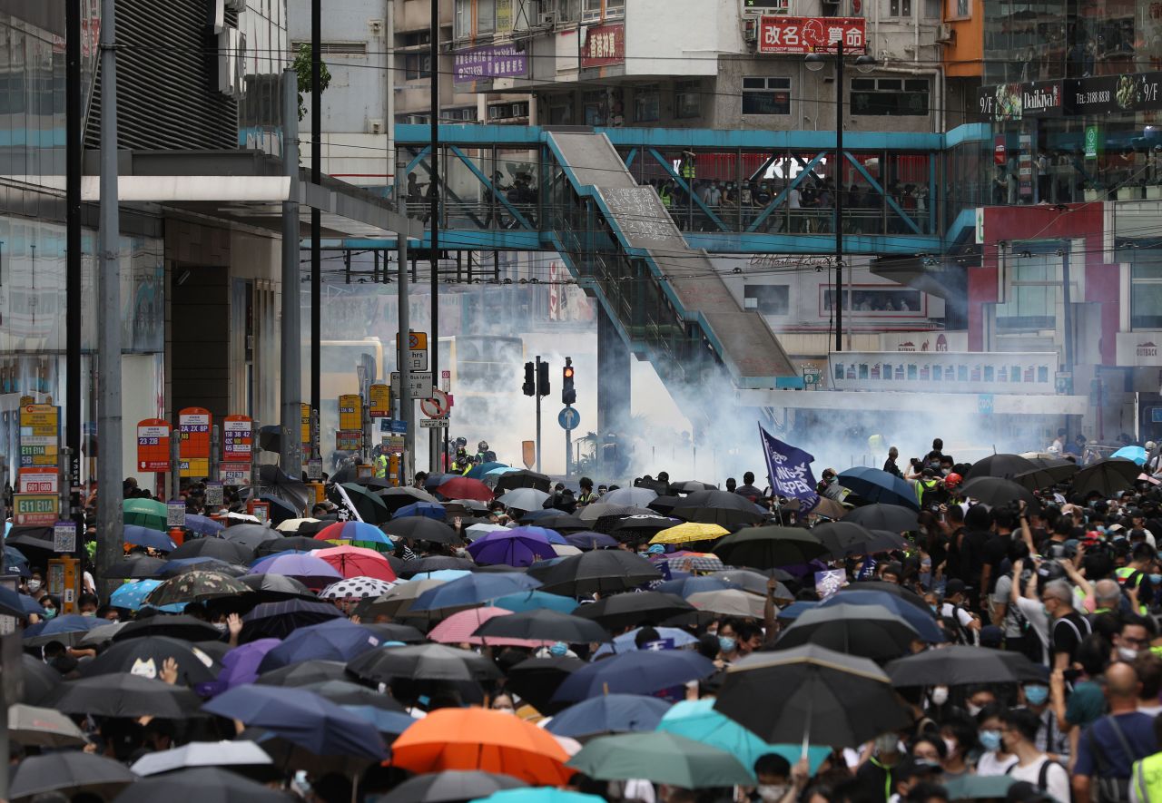 Tear gas is seen in the background as police try to disperse protesters on May 24.