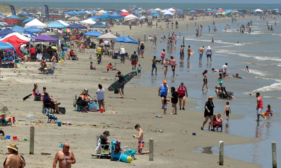 Beachgoers gather in Port Aransas, Texas, on Saturday as Americans head to the coasts this weekend.