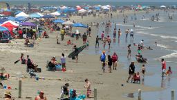 People gather on the beach for the Memorial Day weekend in Port Aransas, Texas, Saturday, May 23, 2020. Beachgoers are being urged to practice social distancing to guard against COVID-19. 
