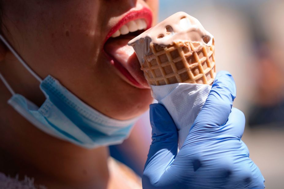 A woman eats an ice cream cone on the boardwalk in Ocean City, Maryland, on Saturday.