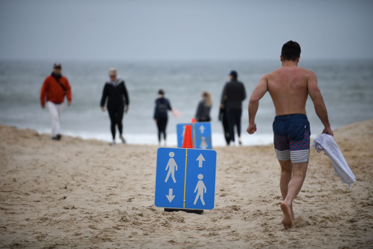 Signs placed on the beach in Montauk, New York, direct people on how to follow social distance measures on Sunday.