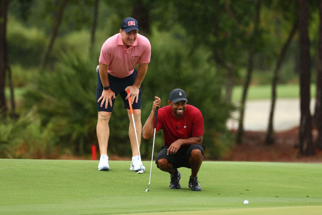 Woods and Manning read a putt on the sixth green during The Match: Champions For Charity at Medalist Golf Club.