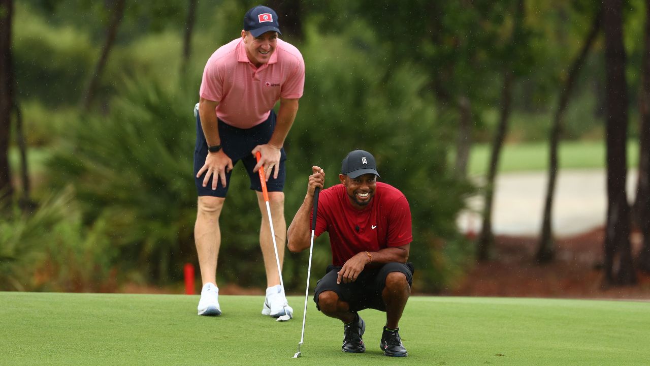 Woods and Manning read a putt on the sixth green during The Match: Champions For Charity at Medalist Golf Club.