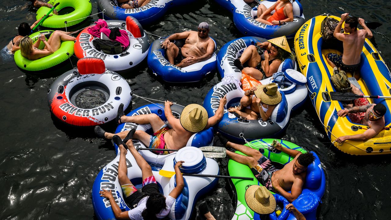 A group of people float on connected inflatables down the American River near Rancho Cordova, California, on Memorial Day Weekend.