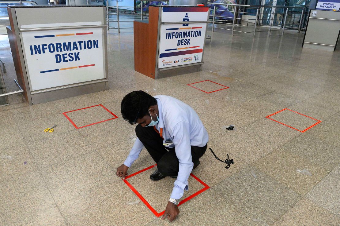 A worker marks squares on the ground at the Rajiv Gandhi International Airport in Hyderabad.