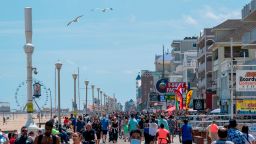 People enjoy the boardwalk during the Memorial Day holiday weekend amid the coronavirus pandemic on May 23, 2020 in Ocean City, Maryland. - The beach front destination has lifted its COVID-19 related beach and boardwalk restrictions May 9 and lodging restrictions May 14. The state of Maryland moved from a stay-at-home order to safe-at-home order May 15.