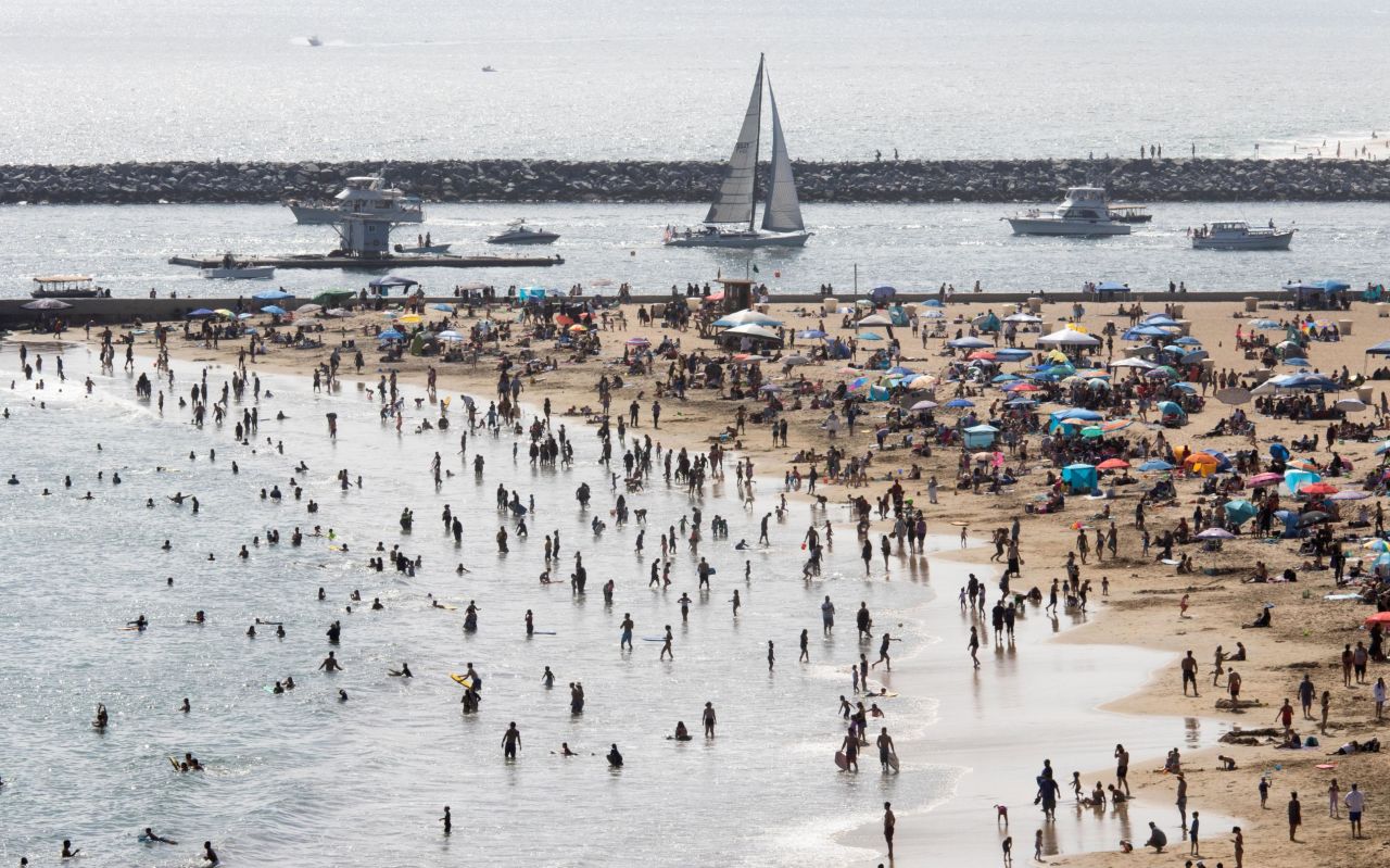 Beachgoers gather in Newport Beach, California, on Sunday.
