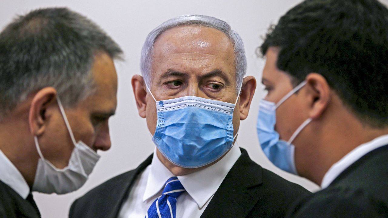 Israeli Prime Minister Benjamin Netanyahu speaks with his lawyer inside a courtroom in Jerusalem on May 24, 2020, during the first day of his corruption trial. 