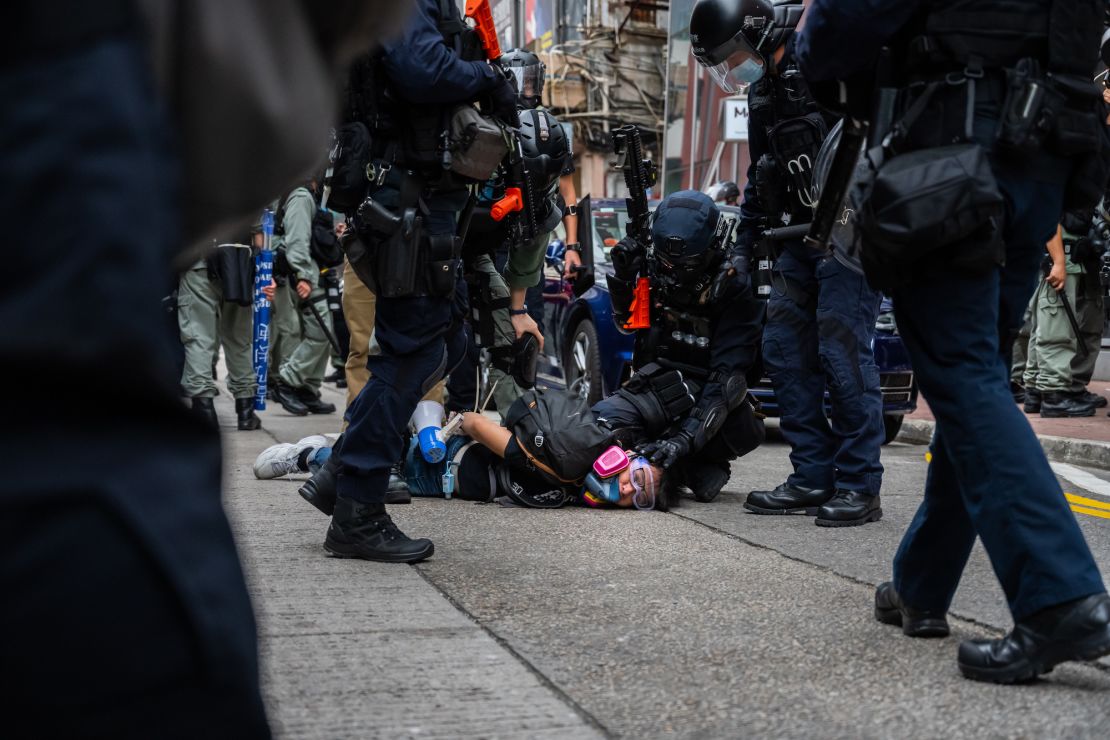 A protester is detained by riot police in Hong Kong on May 24.