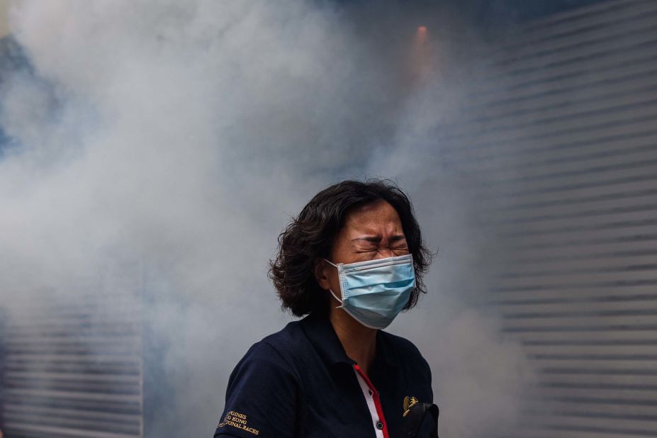A woman reacts to tear gas on May 24.