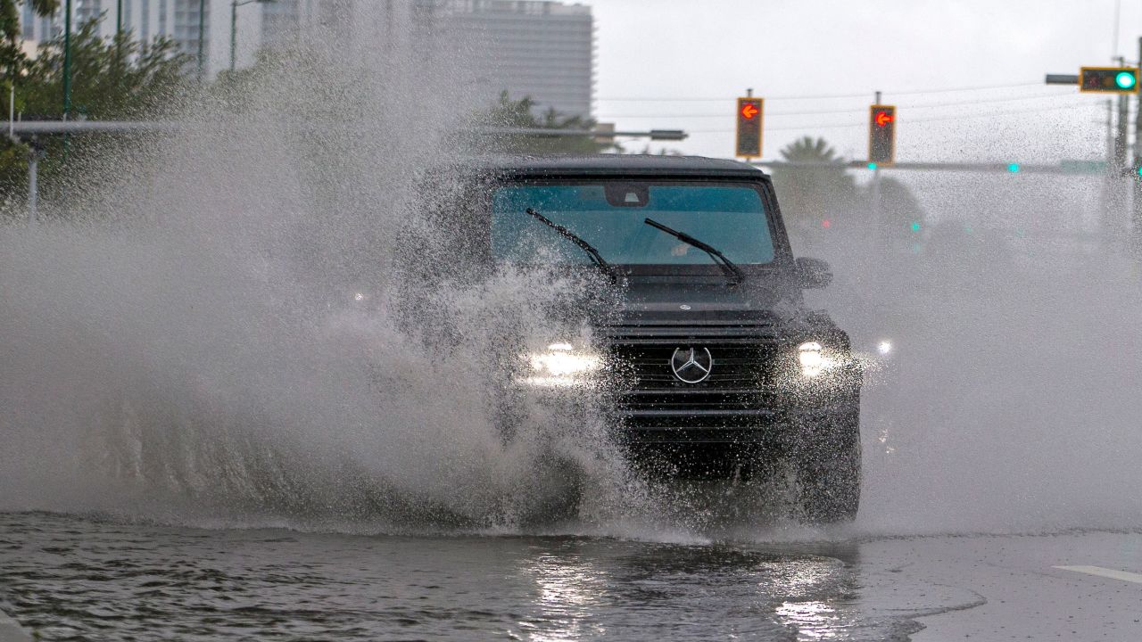 Cars pass through flooding caused by heavy rains on Biscayne Boulevard in Aventura, Florida, on Sunday, May 24, 2020.