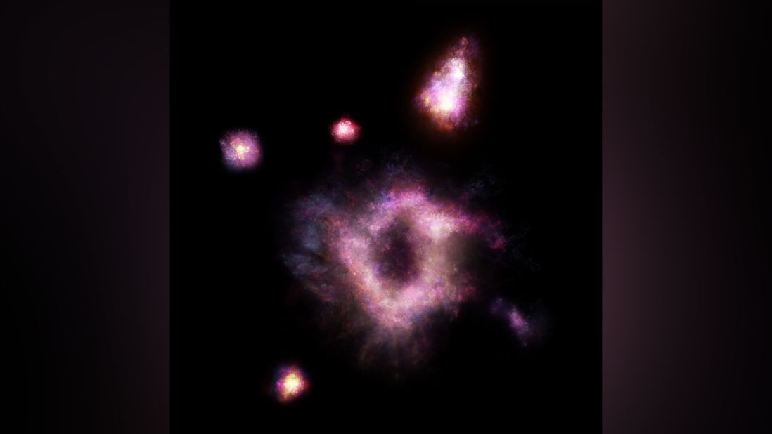  Astronomers have discovered a rare type of galaxy described as a "cosmic ring of fire." This artist's illustration shows the galaxy as it existed 11 billion years ago.