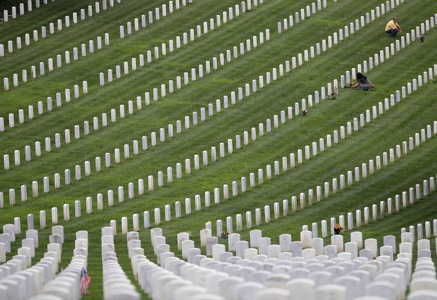 Visitors pay respects at Fort Rosecrans National Cemetery in San Diego on Monday.
