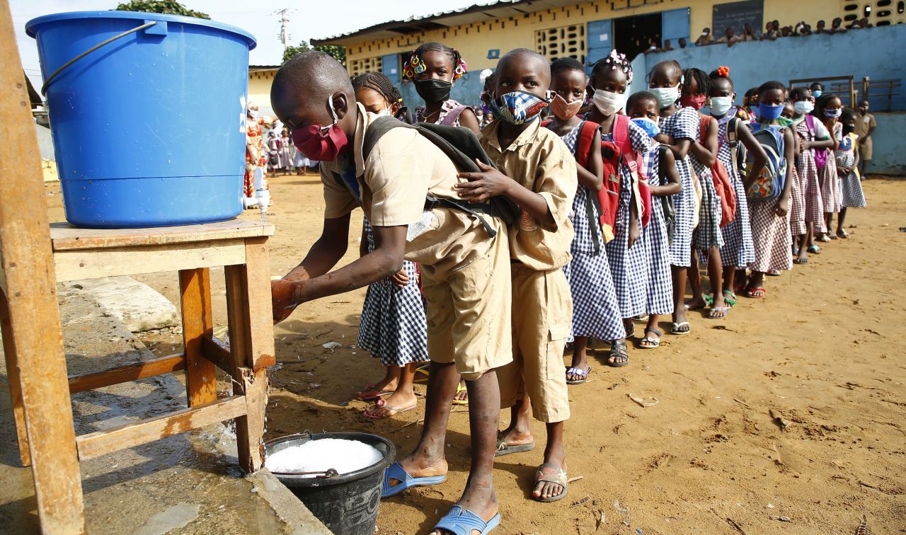 Preschool students wait to wash their hands before class in Abidjan, Ivory Coast, on May 25, 2020. The country became one of the first in West Africa to restart lessons after a two-month coronavirus shutdown. 