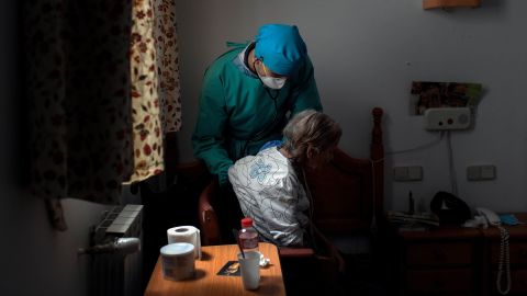 A doctor examines an isolated resident at a nursing home in Madrid, Spain on April 24.  
