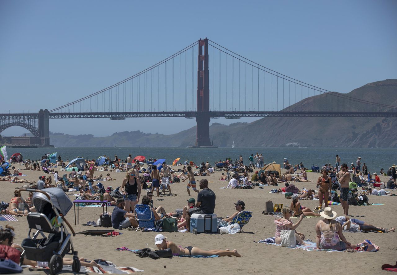 People visit a beach near the Golden Gate Bridge in San Francisco on Monday.