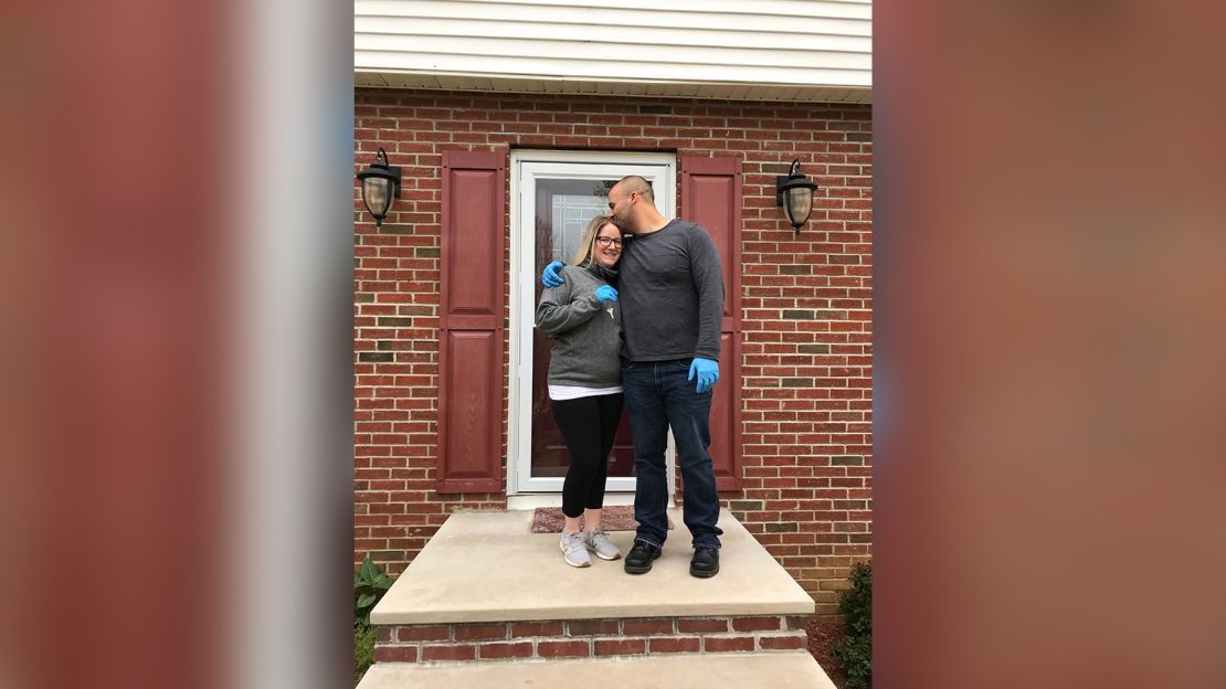 Amanda Stone and Scott Maraldo in front of the home they bought that Scott had never visited.