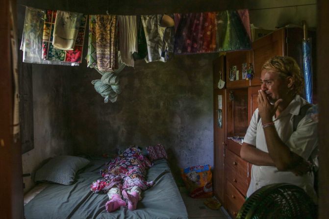 A man waits for his aunt's body to be collected in Manaus on May 24. The public funeral service provided by Manaus City Hall, which helps low-income families hold burials, has seen a dramatic increase in demand due to the coronavirus outbreak.