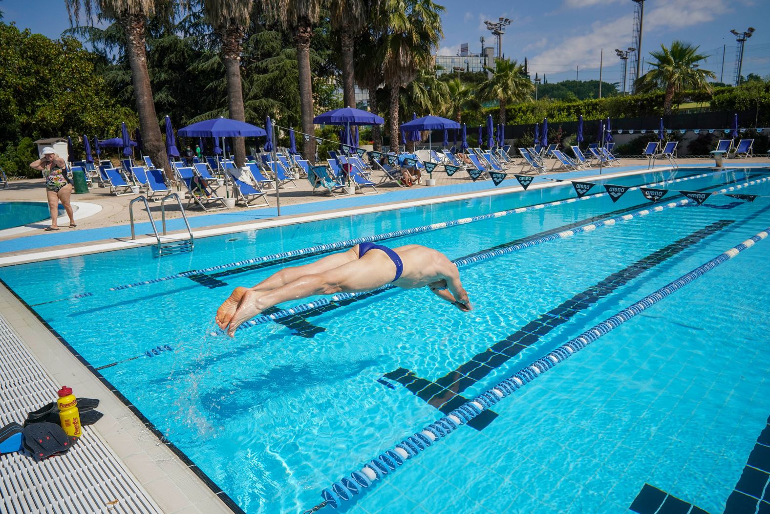 A man dives into an outdoor swimming pool in Rome on May 25.