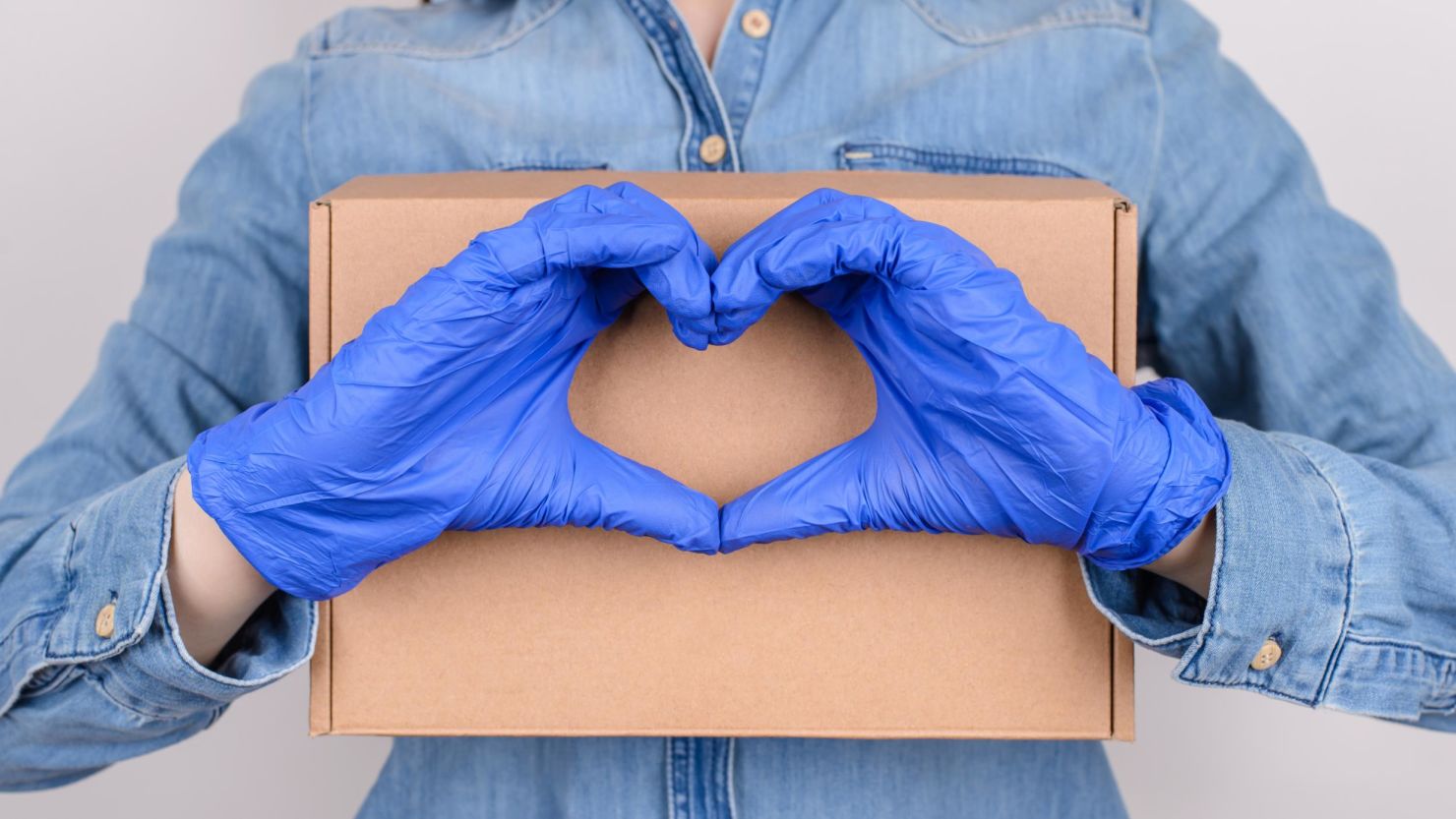 Asian Delivery Man Holding Shopping Bag In Medical Rubber Gloves