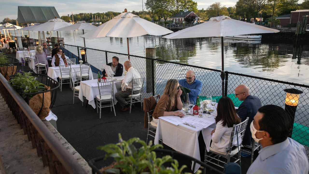 A waiter serves patrons at L'escale restaurant in Greenwich, Connecticut.