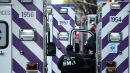 NEW YORK, NEW YORK - MAY 01: A City of New York EMS paramedic stands among several ambulances  during the coronavirus pandemic on May 1, 2020 in New York City. COVID-19 has spread to most countries around the world, claiming over 239,000 lives and infecting over 3.3 million people (Photo by John Lamparski/Getty Images)